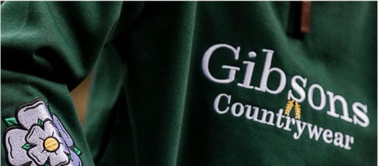 Green jacket with 'Gibsons Countrywear' logo and yorkshire rose design on sleeve