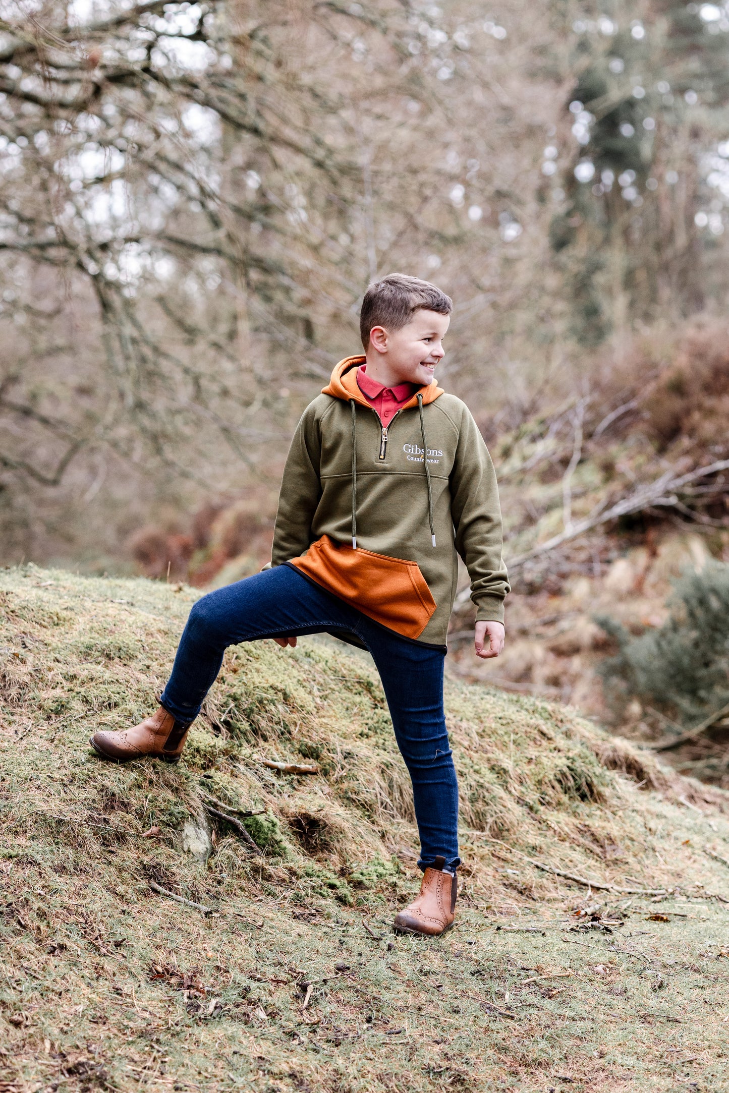 Child standing on a rock in a forest